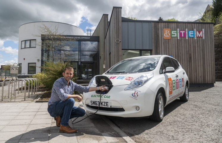 Greg Steel with electric car