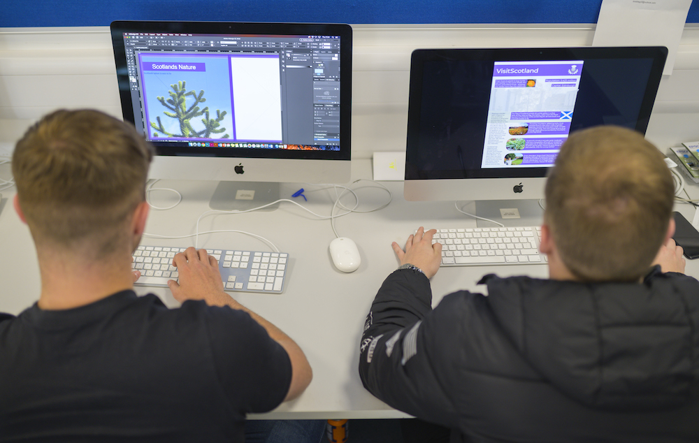 two students sat facing computers