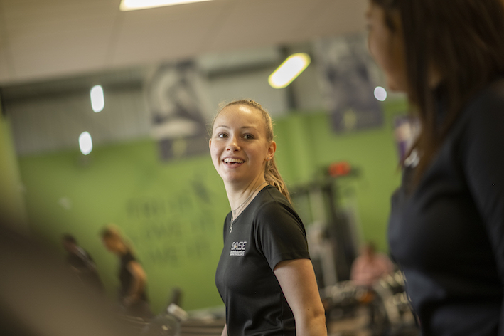 female student using gym equipment