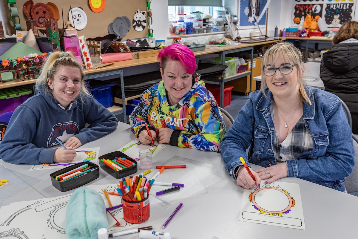 Group of childcare students sitting in a classroom setting