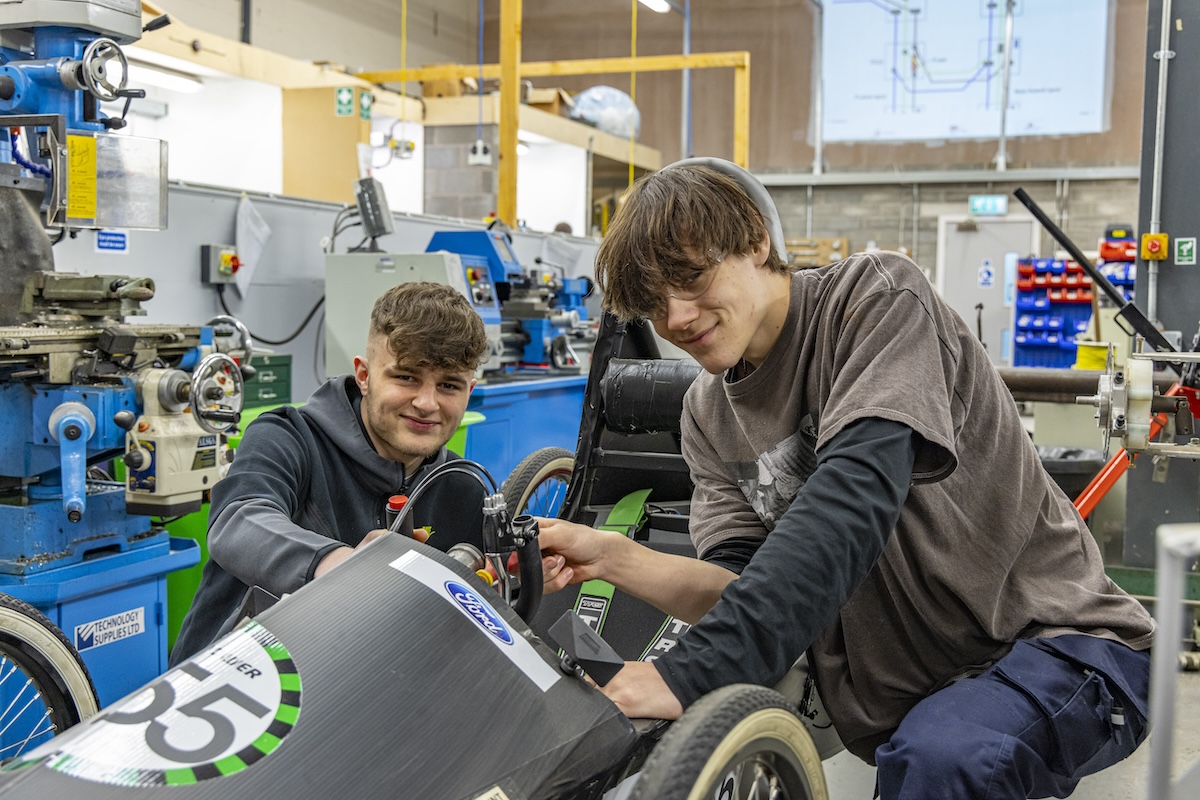 Two male students in an engineering workshop