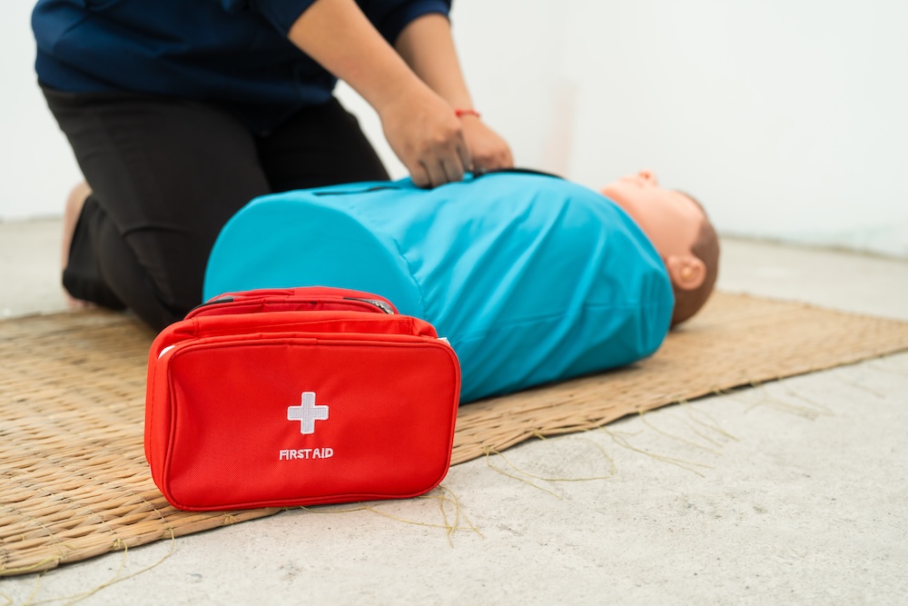 Photo of a person performing first aid on a dummy