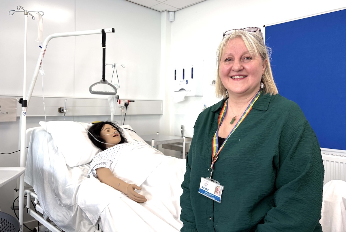 Picture of a person standing in a simulated hospital ward setting