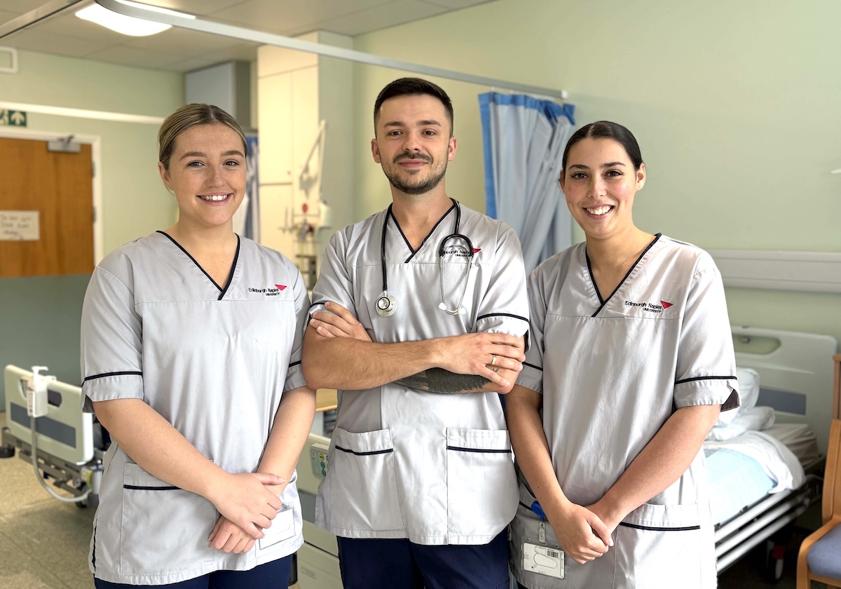 Photo of three nurses standing in a hospital ward