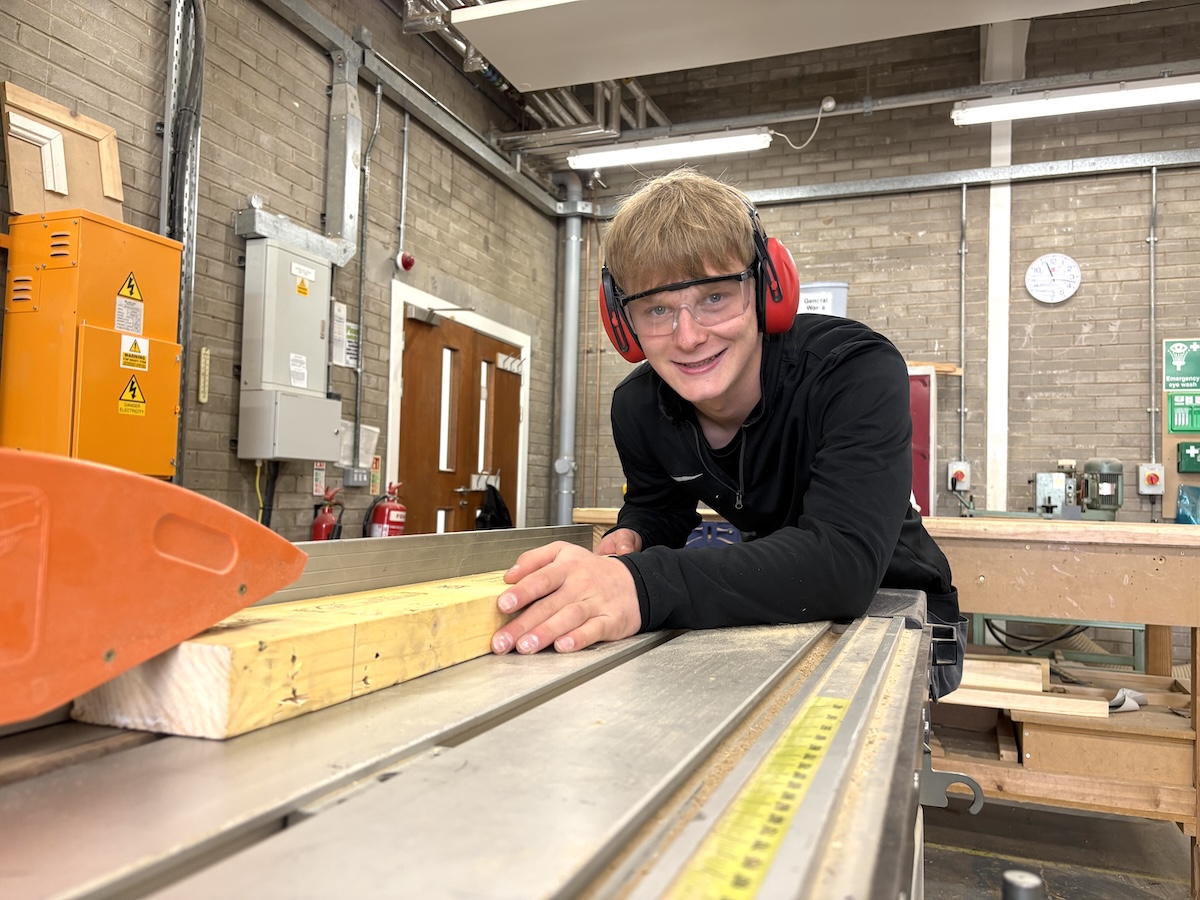 Picture of a joinery student using machinery in a carpentry workshop