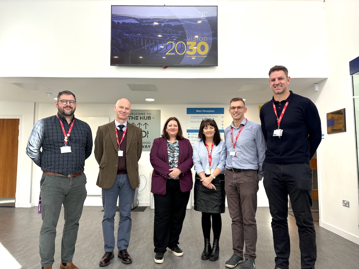 Group of Borders College staff standing with MP Kirsty McNeil in the Borders College Reception area
