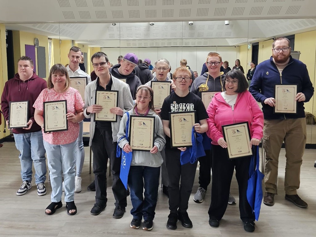 Group of Pathways students holding completion certificates